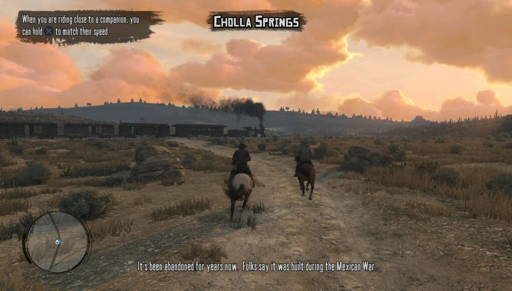 Miehet ratsastavat junan vieressä.