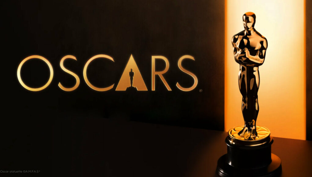 Kultainen Oscar-patsas ja Oscars-logo tummalla taustalla, jossa on lämmin kultainen valaistus.