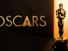 Oscar-pystit jaettiin – katso tästä kaikki voittajat Kultainen Oscar-patsas ja Oscars-logo tummalla taustalla, jossa on lämmin kultainen valaistus.