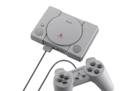 Playstation 1 saa oman Lego-versionsa Viistosta kuvattu alkuperäinen harmaa Sony PlayStation (PS1) -konsoli, jonka edessä on siihen kytketty klassinen ohjain. Konsolin päällä näkyvät pyöreä CD-aseman kansi, virta- ja avauspainikkeet sekä PlayStation-logo.