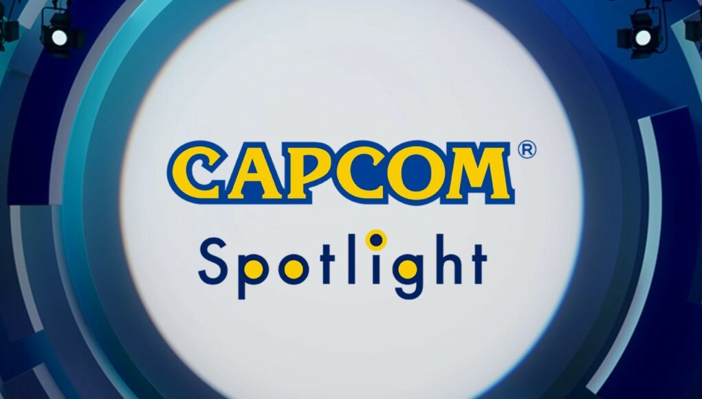 Grafiikka, jossa lukee keskellä kelta-sinisin kirjaimin "CAPCOM Spotlight" valkoisessa ympyrässä, jota ympäröivät siniset, abstraktit muodot ja valonheittimet.