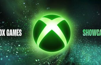 Missasitko Xbox Games Showcase 2026:n julkistukset? Ei hätää, näet kaiken tästä Tapahtuman mainoskuva, jonka keskellä on suuri, kirkkaanvihreänä hohtava pyöreä Xbox-logo valkoisella X-kirjaimella. Tausta on tumma, avaruusmainen ja täynnä vihreitä sekä valkoisia kimaltelevia hiukkasia ja tähtipölyä, jotka luovat dynaamisen kaartuvan efektin logon ympärille. Vihreän logon vasemmalla puolella lukee valkoisella selkeällä fontilla "XBOX GAMES" ja oikealla puolella vihreällä fontilla "SHOWCASE"