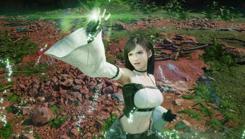 Kuvassa on Final Fantasy VII -pelisarjasta tuttu Tifa Lockhart, jolla on yllään hänen tunnusomainen asunsa (valkoinen toppi, mustat käsineet ja pitkät hihansuut), ja hän loihtii tai käyttää taikuutta (vihreitä hiukkasia ja valoa kämmeneessään) ulkoilma-alueella, jossa on kivikkoa, maata ja kasvillisuutta.
