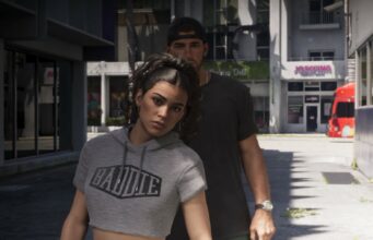 Kiristystä kryptovaluutalla: GTA 6 -vuotaja Cyberleek vaatii Take-Two:lta julkista anteeksipyyntöä Grand Theft Auto VI -pelin kuvakaappaus, jossa harmaaseen crop top -huppariin pukeutunut Lucia ja lippalakkia pitävä Jason kävelevät ulkona kaupunkimiljöössä päivänvalossa.
